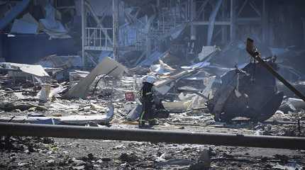 Ukrainian firefighter works near a destroyed building  of Odesa