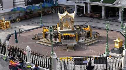 Flower vendors sit outside Erawan Shrine in Bangkok