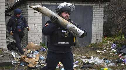 Ukrainian sapper carries a part of a projectile