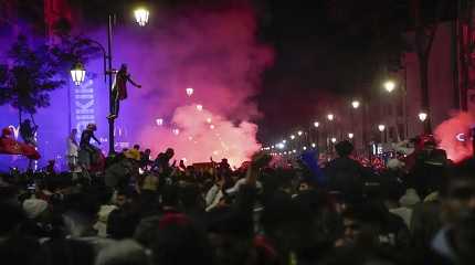 Moroccans gather to celebrate Morocco's win over Spain in a World Cup