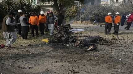 Security officials and rescue workers gather at the site