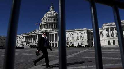 man walks past the U.S. Capitol building