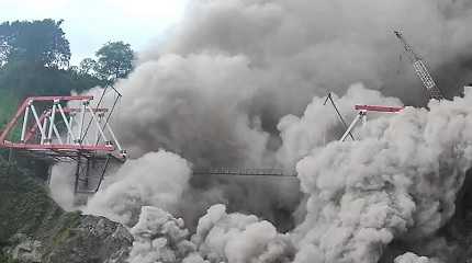 spewing volcanic materials near a new bridge