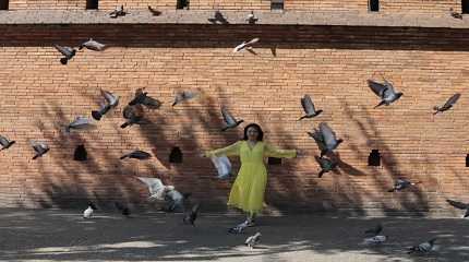 Chinese tourist poses for a picture