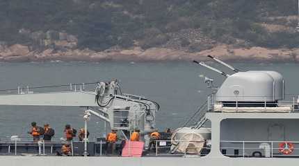 Soldiers stand on the deck of a Chinese warship