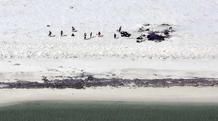 fishermen from Indonesia stand on a beach on Bedwell Island