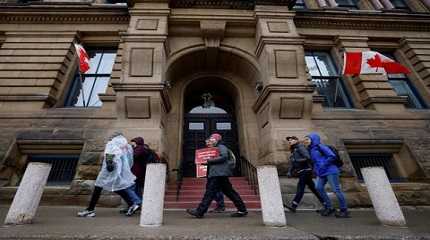 Picketers march around the Office