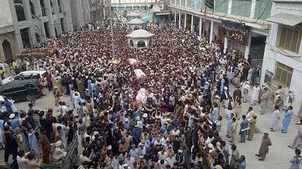 Shiite Muslims carry the coffins of teachers