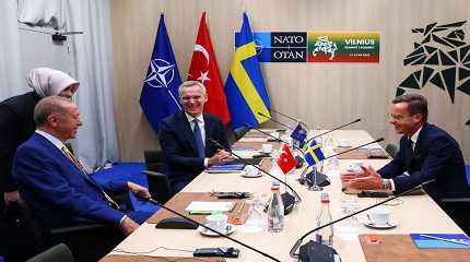 Jens Stoltenberg, Tayyip Erdogan and Ulf Kristersson react during a meeting