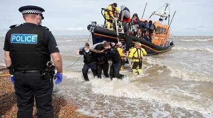 RNLI boat with migrants onboard