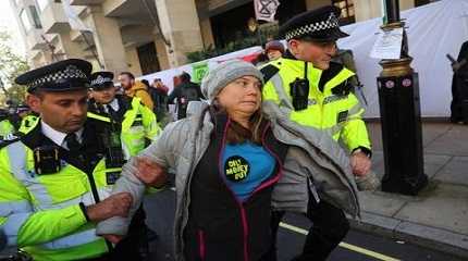 Police officers detain Greta Thunberg.,