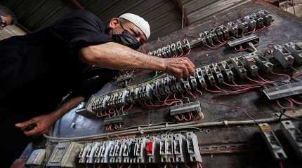 A man works on an electrical generator