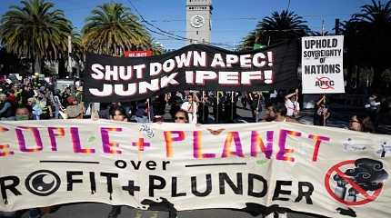 Demonstrators hold placards