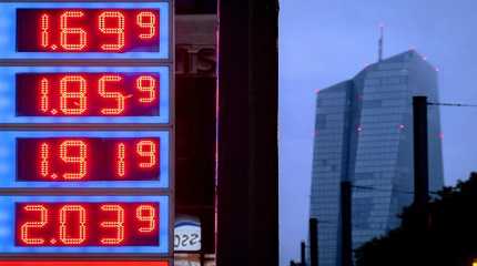 Gas prices are displayed at a gas station