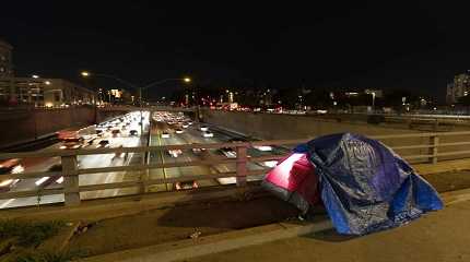 homeless person’s tent on a bridge