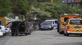 Police and emergency forces stand near a school 