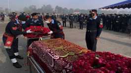 Police officers attend the funeral prayer of a colleague