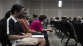 People pray during a prayer vigil in Irvine