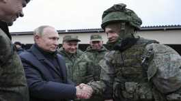 Putin shakes hands with a soldier