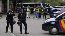 Police officers stand guard Ukrainian embassy in Madrid