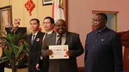 medical worker displays his certificate during a graduation ceremony