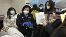 officer collects passports from residents