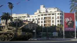 tank is seen next to the portrait of former Tunisian President