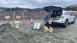 man loads the sandbags in his car 