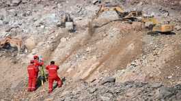 rescuers work at the site of a collapsed