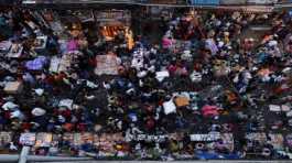 People shop at a crowded market