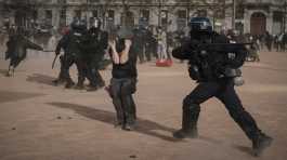 Police officers scuffle with protesters