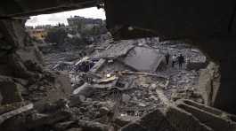 Palestinians inspect the rubble