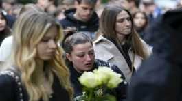 People bring flowers for the victims in front of the Vladimir Ribnikar school 