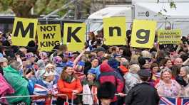 Protesters wave Not My King signs near to the King Procession