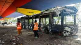 public bus afire by supporters of Imran Khan during a protest