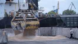 Workers load grain at a grain port in Izmail..,.