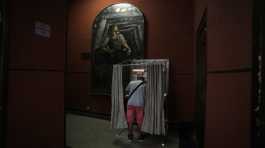 voter stands in a booth at a polling station