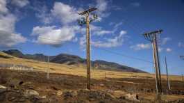 Bare electrical wire and leaning poles