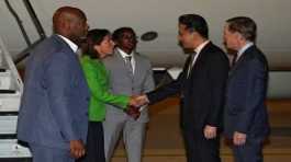 Gina Raimondo, shakes hands with Lin Feng