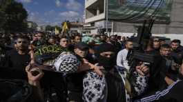 Mourners carry the bodies 